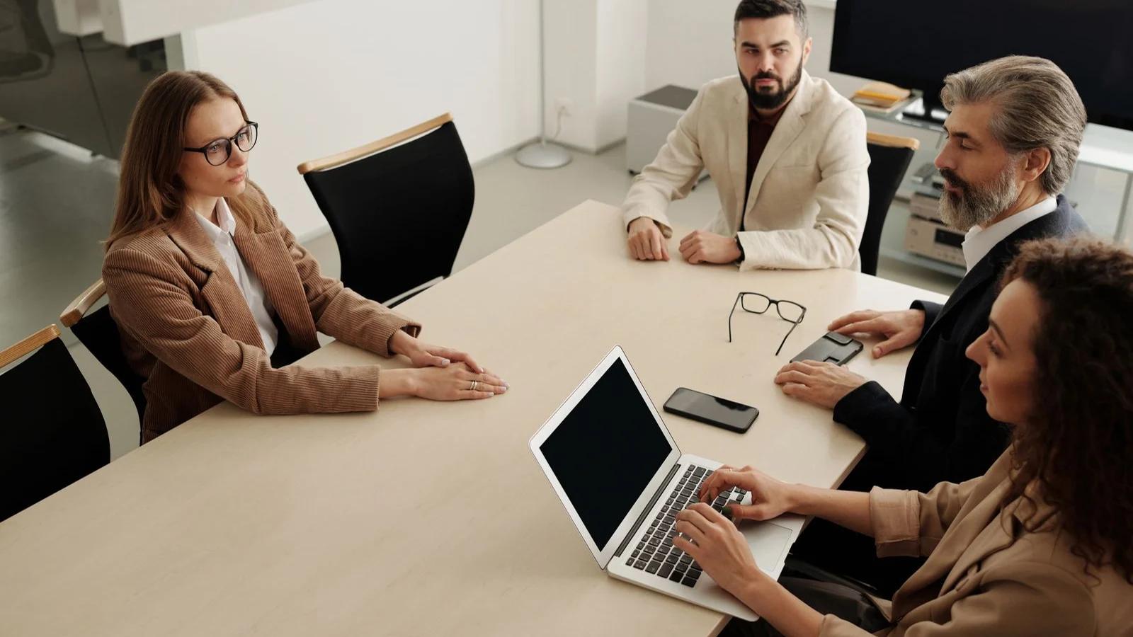 Professionals discussing ideas around a meeting table