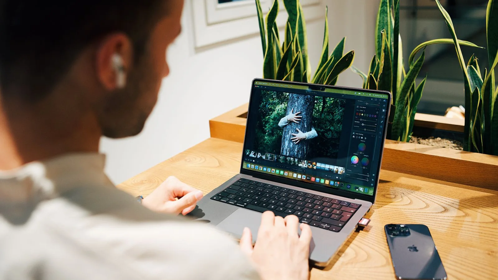 A person editing photographs on a laptop