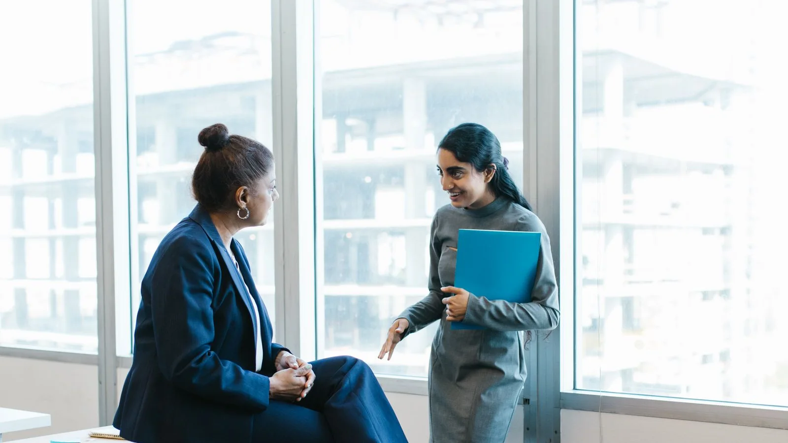 Two professionals talking together in an office