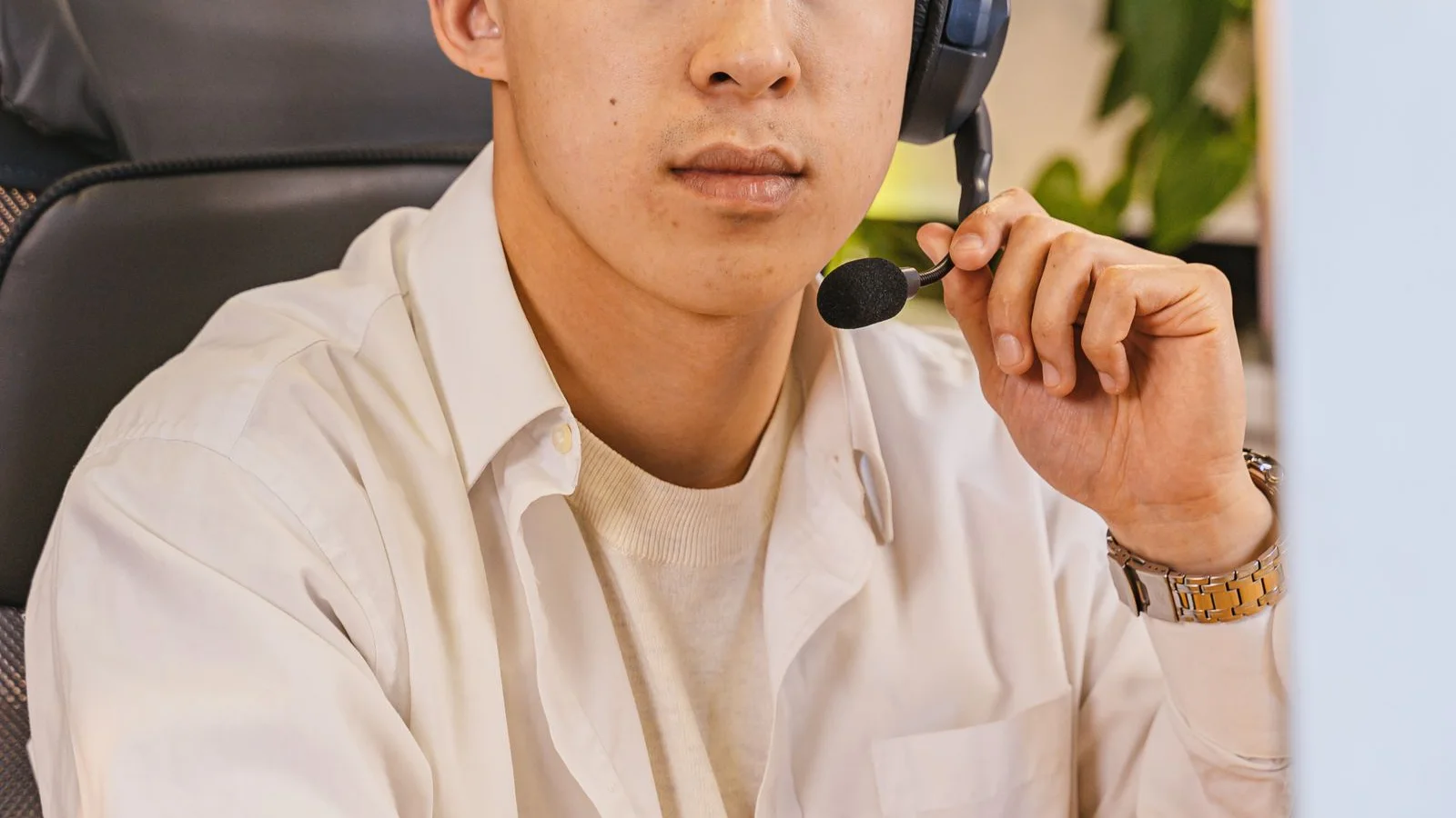 An office professional using a headset at a desk